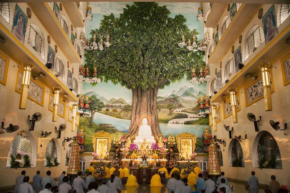 Worshippers gathered inside the temple under a mural of the Bodhi tree in Ho Chi Minh City, Vietnam.