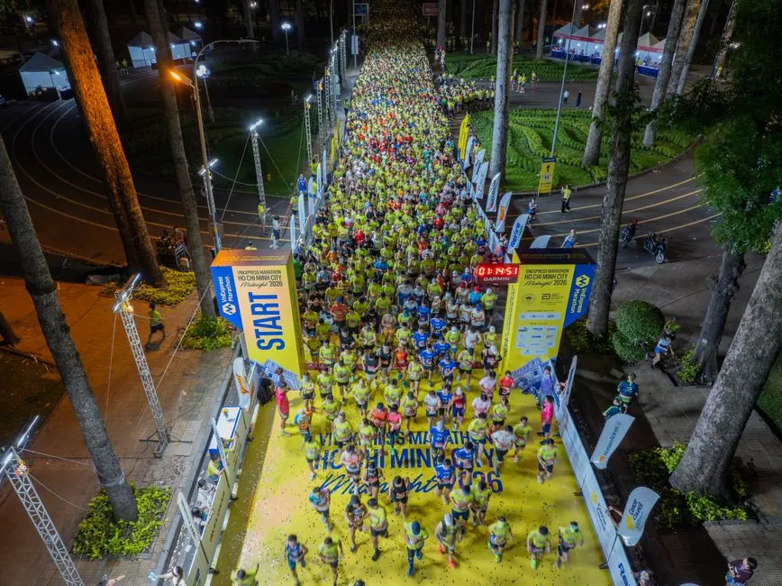 Aerial view of runners starting the Ho Chi Minh City Marathon at night.