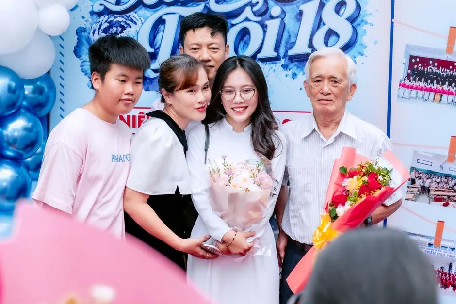 A joyful family gathering to celebrate a special graduation event with flowers and smiles.