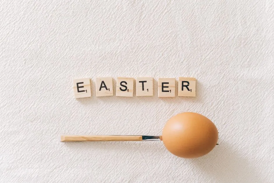 A creative Easter concept featuring a brown egg with Scrabble tiles spelling 'Easter.'